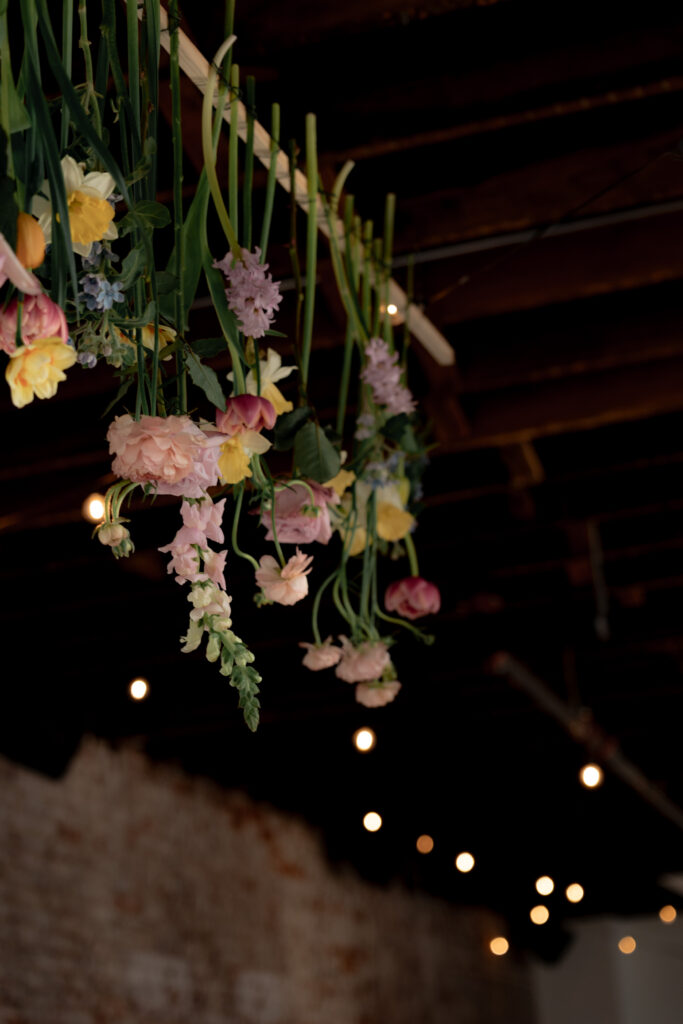 Colorful wildflowers hanging from the ceiling can add a touch of whimsy and magic to any space.