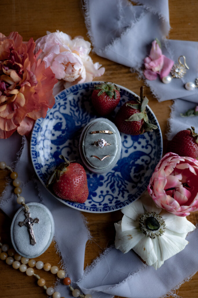 A vintage and whimsical ring flatlay with fruit and flowers.