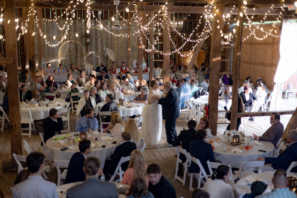 A father-daughter dance with string lights and rustic accents.