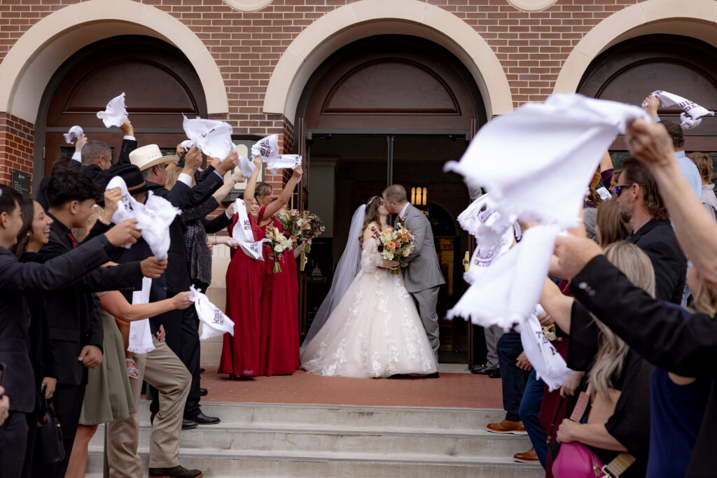 A Texas A&M Catholic Wedding towel grand exit.
