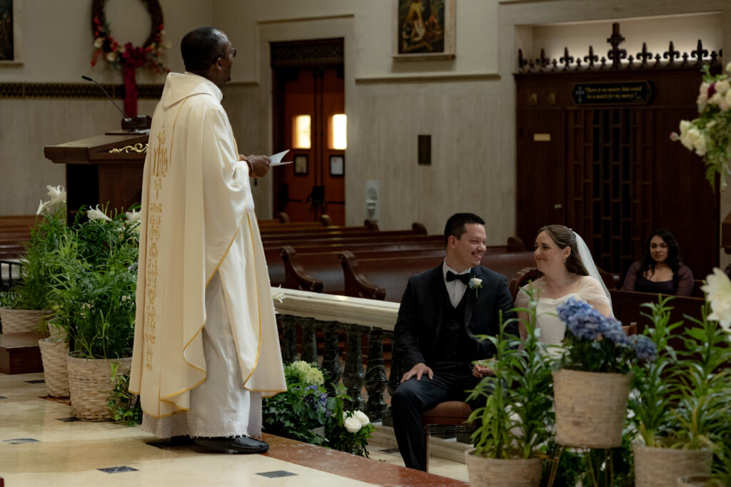 bride and groom share a loving look during a beautiful homily at the Novus Ordo Catholic Mass