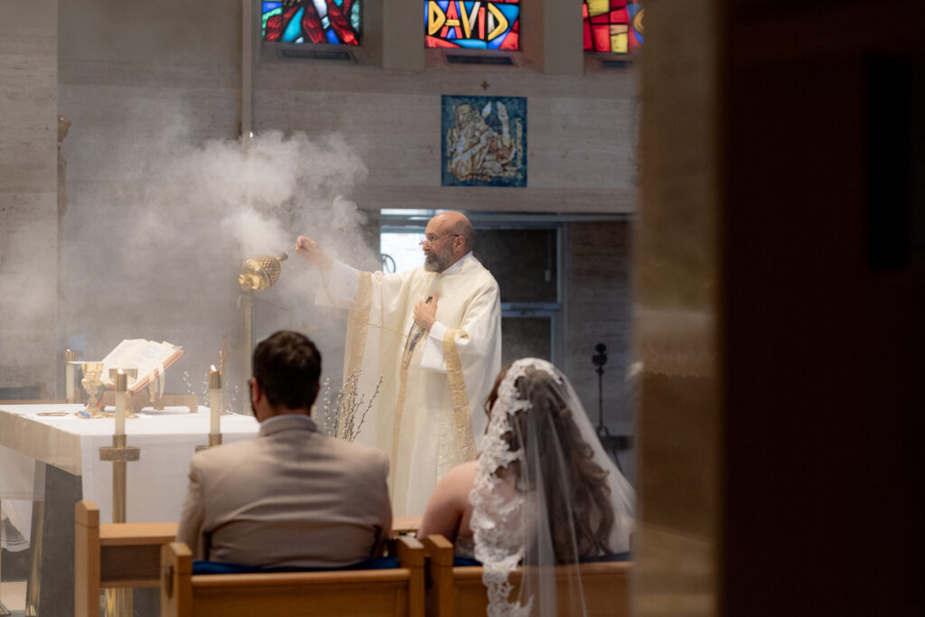 Fr. Valencheck uses incense to bless the altar during the Akron Catholic Wedding. 