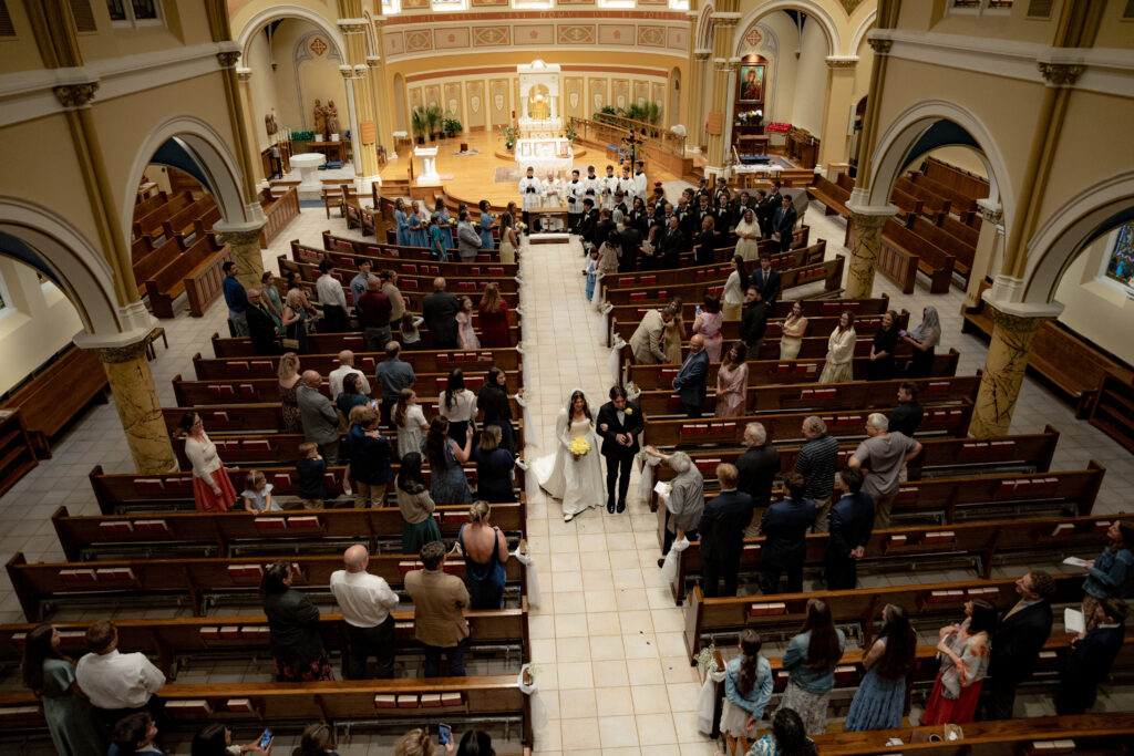 Bride and Groom recess down the aisle of St. Thomas the Apostle Catholic Church in Ann Arbor, Michigan.