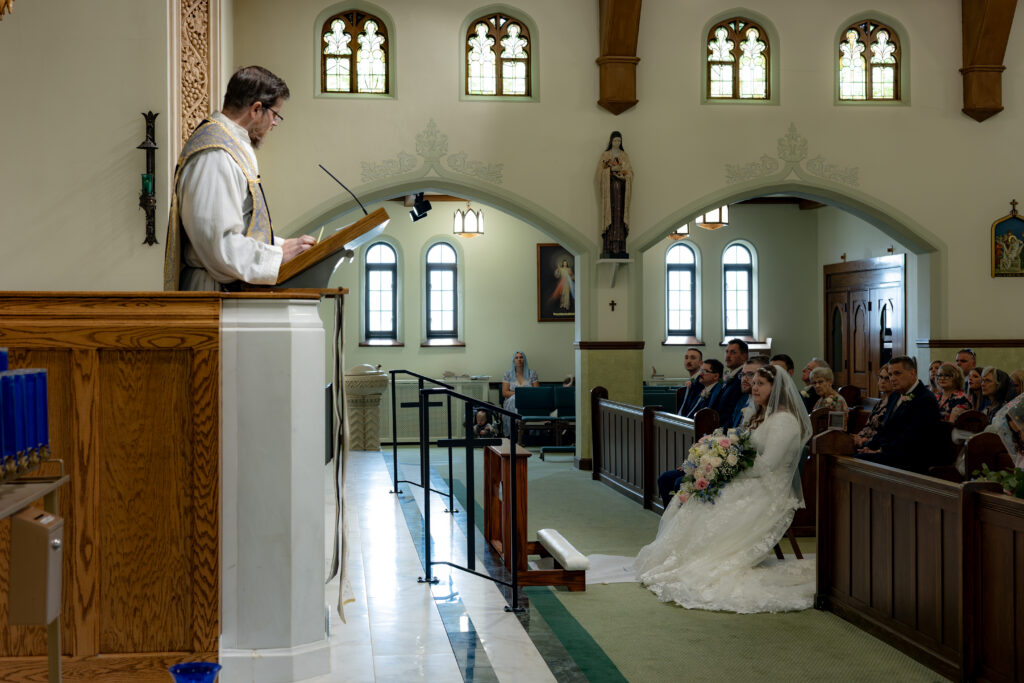 Fr. Pfeiffer gives a homily to the Catholic Couple during their Akron Catholic Wedding.