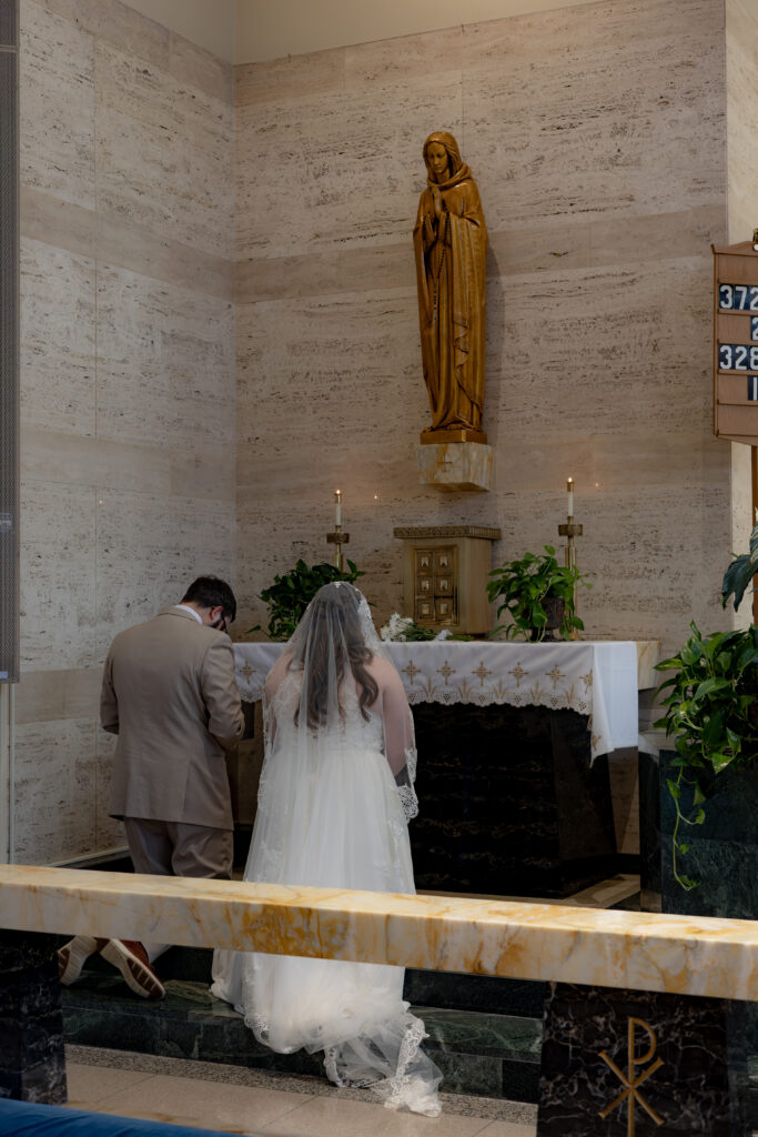 Catholic Bride and Groom honor Mary during their Catholic Wedding Mass at St. Sebastian's Catholic Church in Akron, OH.