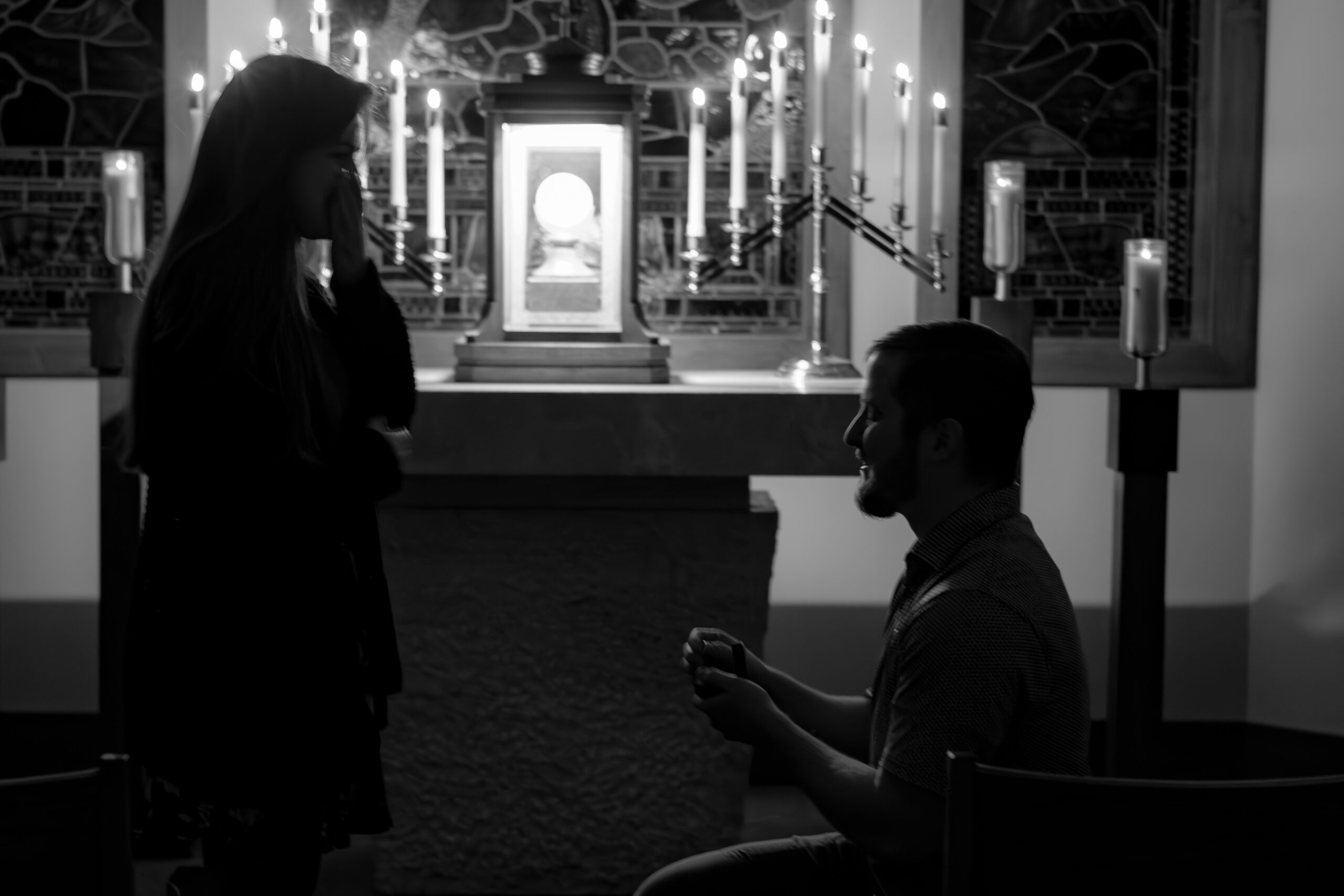 Catholic man proposes to a Catholic woman in front of the Eucharist during adoration.